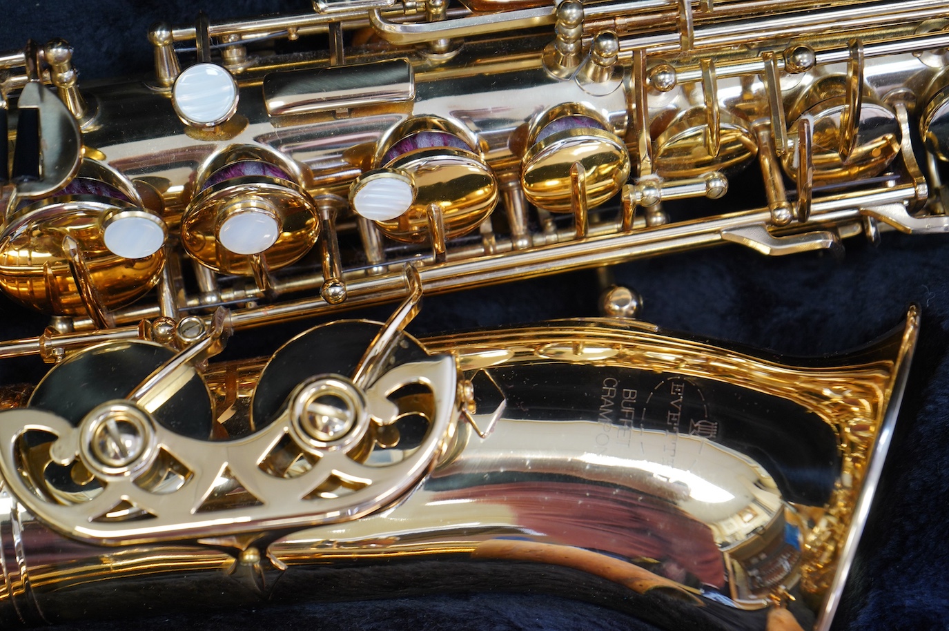 A cased Evette Buffet Crampon brass alto saxophone, together with a saxophone stand. Condition - good